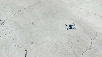 Drone shadow on structural concrete pavement.