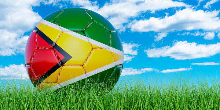 Soccer ball with Guyanese flag on the green grass against blue sky, 3D rendering