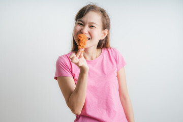 Young asian woman holding and eating fries chicken on white background