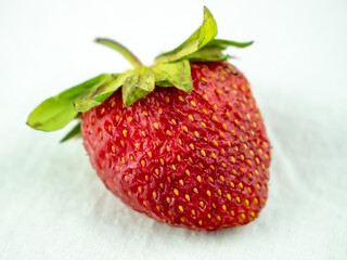 Single fresh strawberry lay on white background