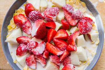 Cornflakes with oat milk and fruit - apple, pear and strawberries 