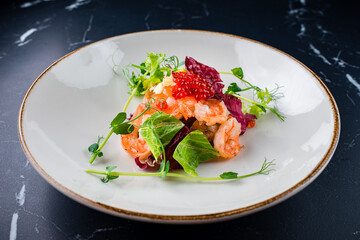 Salad from shrimp tails with lettuce, arugula, cherry tomatoes, avocado, olive oil and balsamic vinegar.