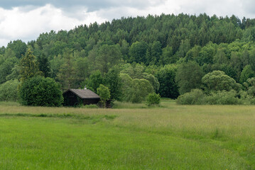 Mountains And Old Wooden Barn In The Field