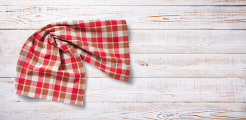 Fototapeta premium Towel or tablecloth, napkin, rough fabric texture with creased folds on wooden desk top view.