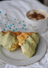 tasty pistachio croissant with coffee