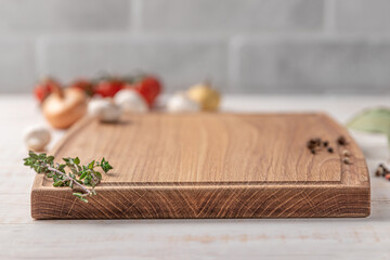 square wooden cutting board with edging. cherry tomatoes and spices on a white background. mockup...