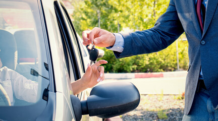 Car salesmen send car keys to new owners.Car rental.