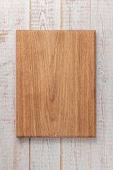 rectangular cutting board on a white wooden table. mockup of a food background with copy space, top view