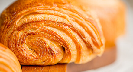 Croissant macro. French croissant with waves. Air baking. Croissant for puff pastry advertising. Croissant for a magazine.French breakfast with pastries. From puff pastry. Bun from France. Roll macro