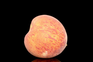 One sweet organic peach, closeup, isolated on black background.