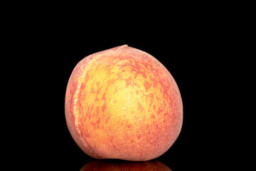 One sweet organic peach, closeup, isolated on black background.