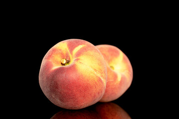 Fototapeta na wymiar Two sweet organic peaches, close-up, isolated on black background.