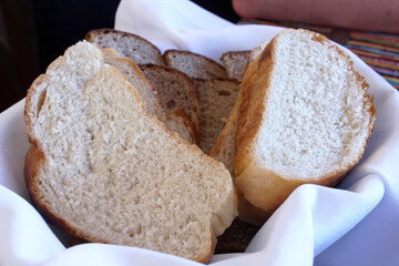 white bread cut into chunks in a plate with a white napkin on the table