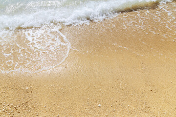 The Mediterranean Sea washes the sandy beach. Sand by the sea, background.