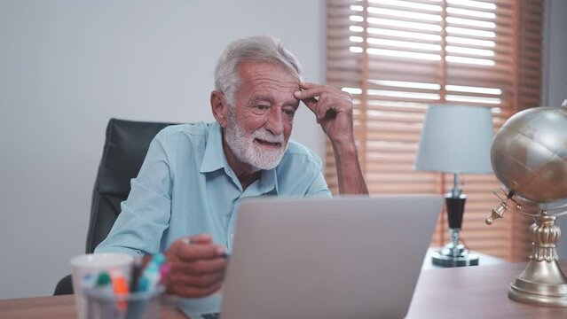elderly caucasian businessman using laptop to work, old adult mature man using computer on desk in business office, male senior entrepreneur with technology at home workplace to teamwork communication