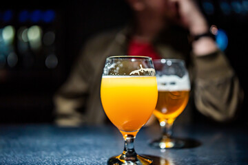 two glass of beer on table at the bar or pub