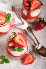 Strawberry Cheesecake. Cheesecake or trifle with strawberry in glass on old gray concrete background table background. Cheesecake without baking. Dessert. New York. Copy space. Food background.
