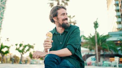 Closeup portrait of smiling interracial couple eating ice cream in urban city background. Close-up...