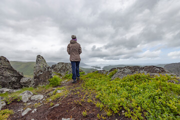 Obraz premium Happy woman hike to the mountains Gaasheituva, Northern Norway- Europe 