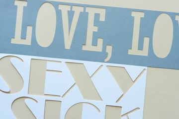 paper stencil with the words: love, comma, sexy, and part of the word sick