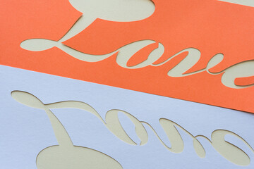 orange and lavender paper stencil with the word love