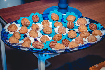 Sweet churros. Small candies on plate for party decoration in blue.