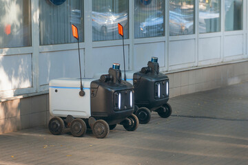 Autonomous Delivery Robots on a sidewalk that make food and package deliveries.
