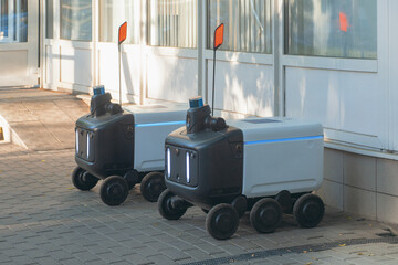 Autonomous Delivery Robots on a sidewalk that make food and package deliveries.