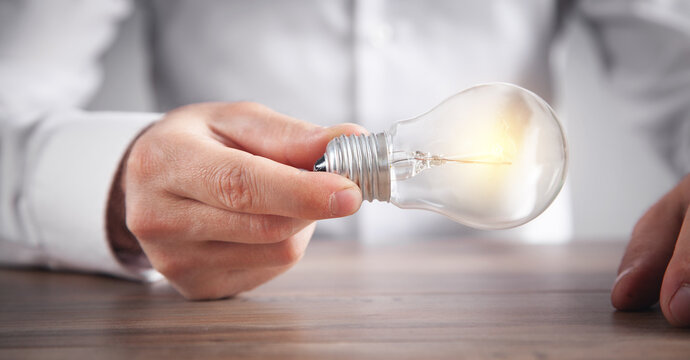 Man holding light bulb. Concept of inspiration and creativity
