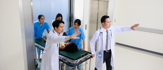 Group of Asian medics or doctors Push Stretcher with Seriously Patient to Operating Room, Emergency Department