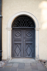 Modern baroque style blue wooden door in old stone white house. Poland, Warsaw.