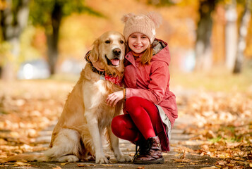 Preteen kid and golden retriever dog