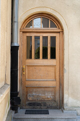 Old brown wooden door with golden door handle