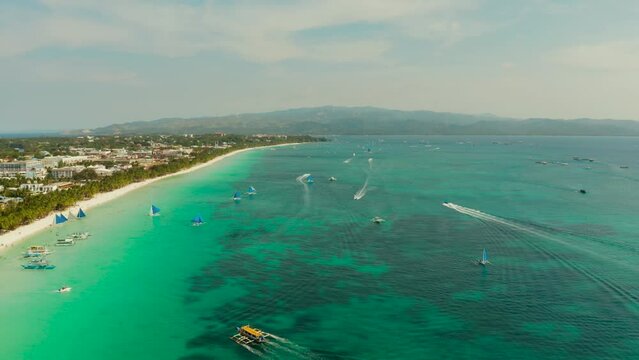 Tropical white sand beach, hotels near the blue lagoon and corall reef. aerial view, Boracay, Philippines. Seascape with beach on tropical island. Summer and travel vacation concept.
