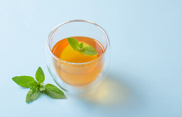 tea with mint and oregano on blue background