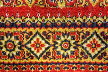 Vintage pattern of an old oriental woolen carpet