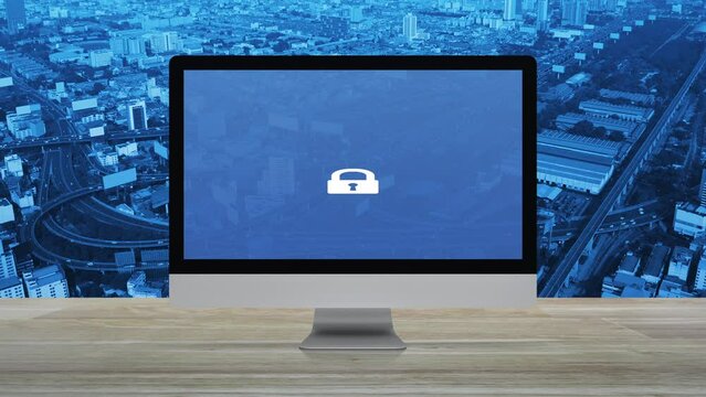Padlock flat icon on desktop modern computer monitor screen on wooden table over city tower, street, expressway and skyscraper, Technology internet cyber security and safety online concept
