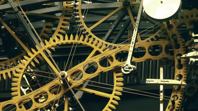 Big clock mechanism with turning cogwheels and gears in action