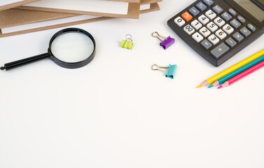 Back to school flatlay with books,calculator,pencils and other supplies on white bacground. Banner with place for text