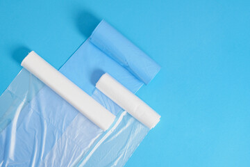 different plastic polyethylene trash bag rolls on blue background