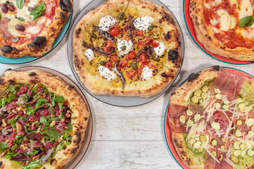 Italian handmade fresh pizza on wooden table high angle view