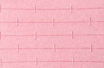 Light pink background from a textile material pattern, closeup. Structure of fabric with natural texture. Cloth backdrop.