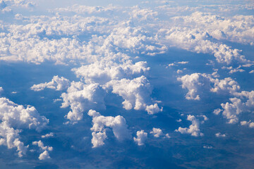 Aerial view of Fluffy clouds Top view from airplane window, Nature background.