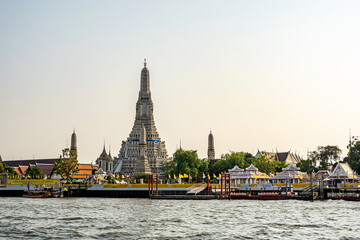 The view of the famous temple called Wat Arun located next to the grand river called chao Phraya in Bangkok city , Thailand. 