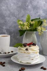Pavlova meringue cakes with whipped cream and fresh strawberries, mint leaves. Selective focus.