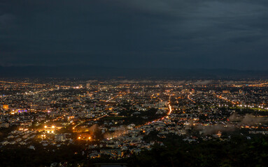 Fototapeta na wymiar The view of the city in the evening from the mountain in Chiang Mai province , Thailand.