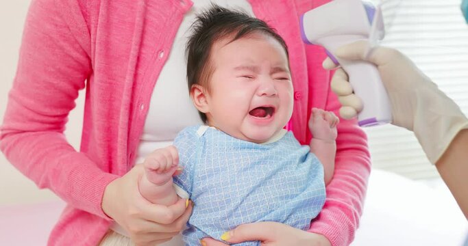 asian doctor examine baby fever