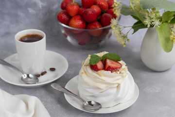 Pavlova meringue cakes with whipped cream and fresh strawberries, mint leaves. Selective focus.