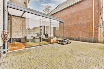 Neat paved patio with sitting area and terrace with glass cube