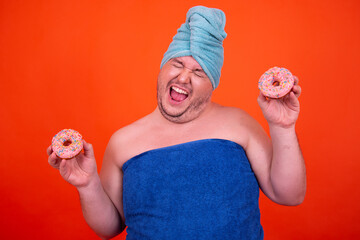 Breakfast and sports. Funny fat man eats donuts.